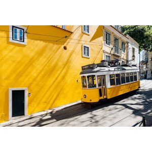 Fotografie Yellow tram moving past yellow building, Alexander Spatari, 40 × 26.7 cm